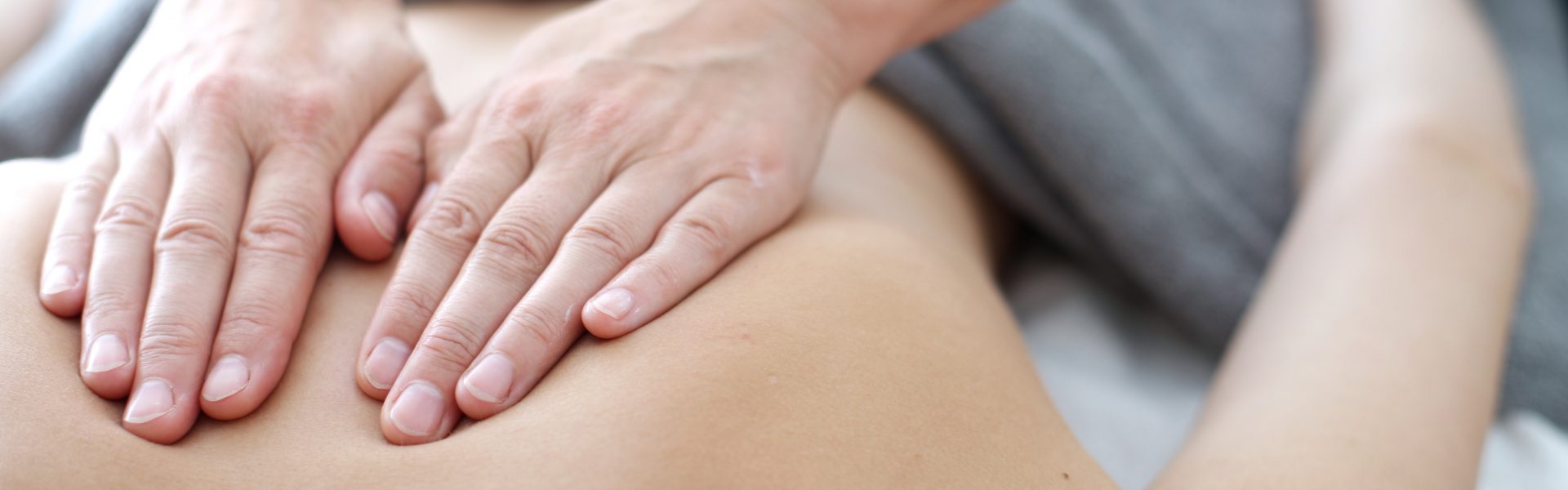 Close up of back massage procedure in spa salon